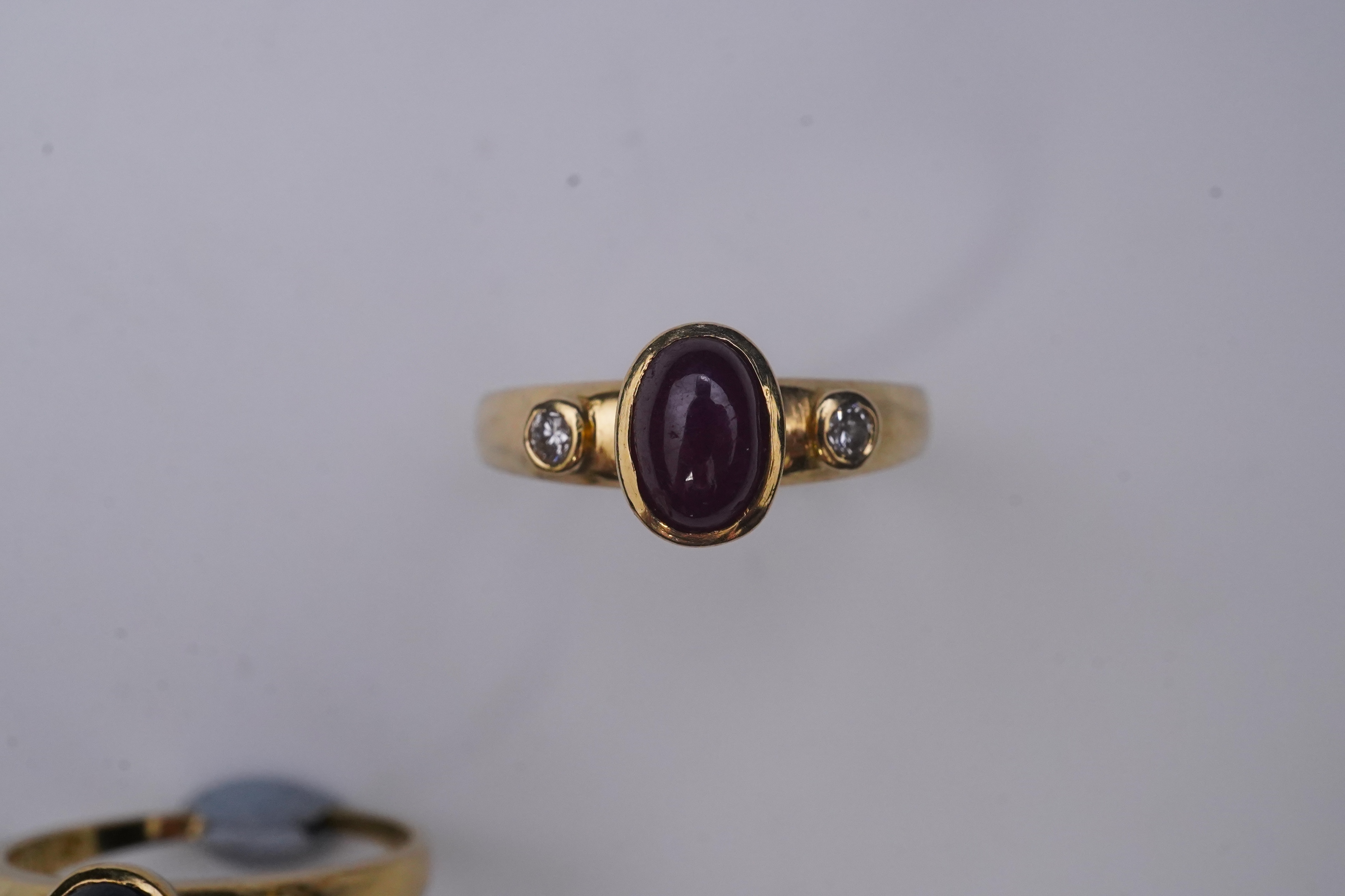 A suite of three gold and gem-set rings